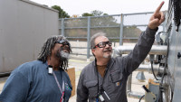 HVAC Technician II Randy Tarver, left, and Facilities Mechanical Technician Michael Leveille assess a piece of equipment.
